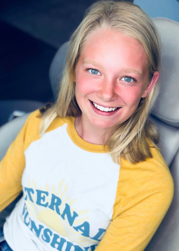 Girl smiling in car seat